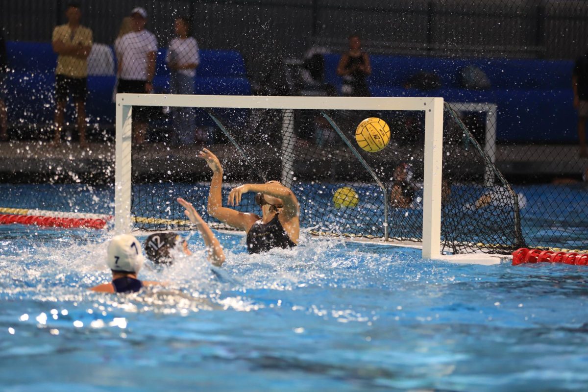 Goalkeeper Maria-Clara (MC) Sliesoraitis ('26) with a huge block against an opposing player.