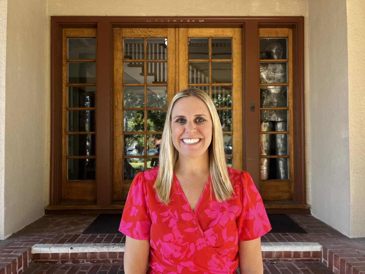 Ms. Andrea Joslyn poses in front of the Andre House for a photo.