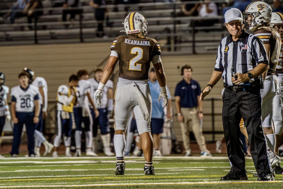 Kingston Keanaaina (’25) stands on the field between plays during the game against Bellarmine College Preparatory. 