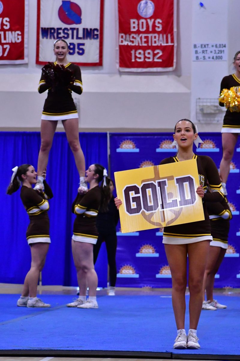 Varsity cheer team shows off their skills at competition.