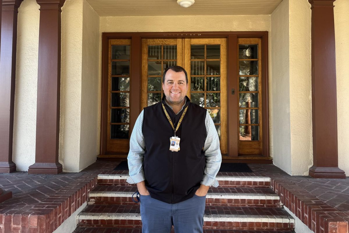 Mr. Nethercott stands in front of the Andre House.