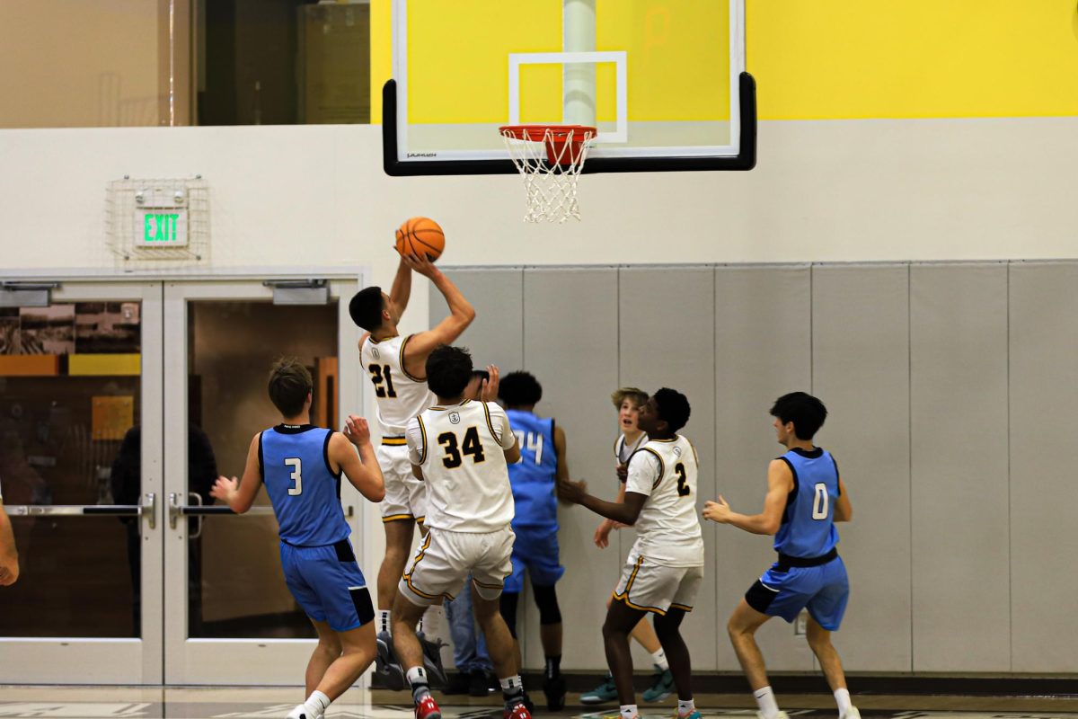 Max Ladd (’25) catches a rebound and shoots a layup.