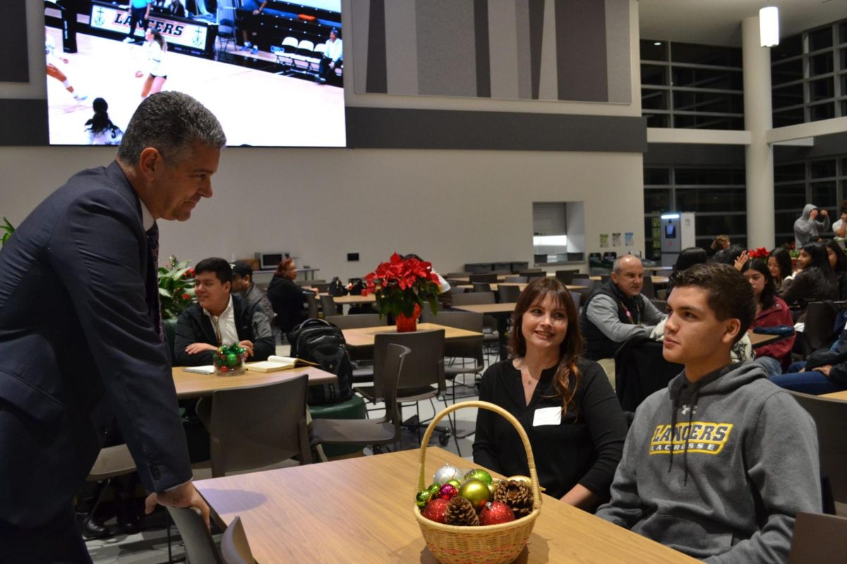 Mr. Curtis talks to a student and his mother.