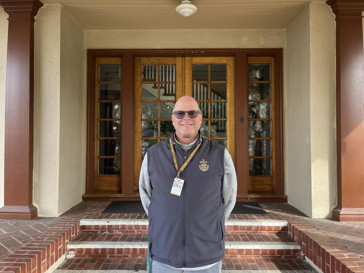 Mr. Meulman smiles for a photo in front of the Andre House.