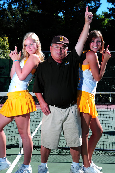 Coach Lynn poses with his tennis players.