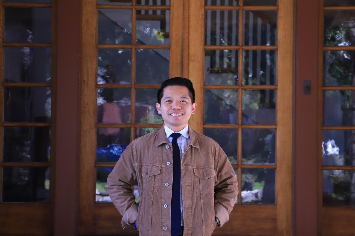 Mr. Bernardo smiles in front of the Andre House.