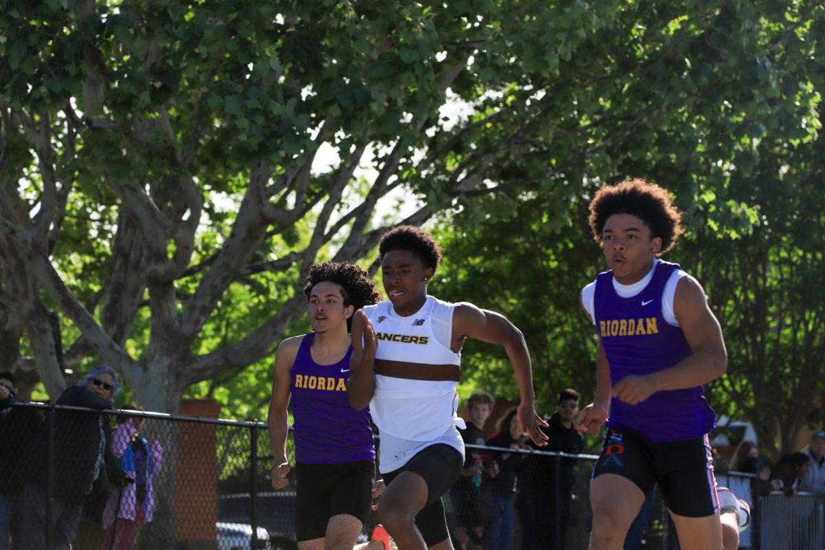 A sprinter is neck and neck with his competitors.