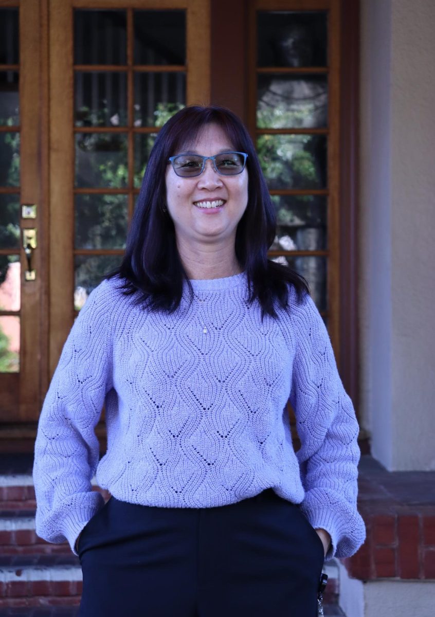 Ms. Yang smiles in front of the Andre House.