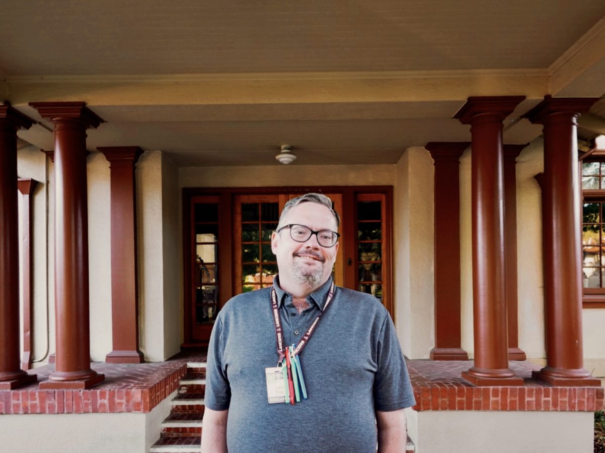 Mr. Foy poses for a picture in front of the Andre House.