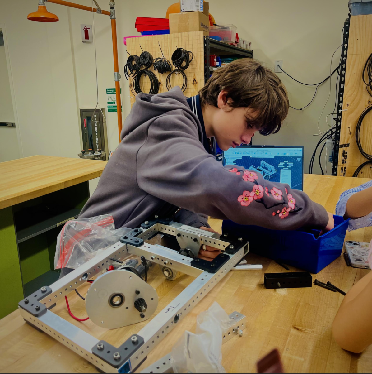 A student works on the frame of their minibot.